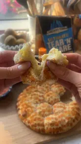 A short, punchy video showcasing a collaboration product between Chicago Town and Frank's RedHot, focusing on the cheese pull and the dipping experience of the pizza dip and dough balls.