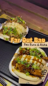 A fast-paced montage showcasing various food vendors at Dockyard Social in Glasgow, including Far Out Bao, Cafe XO, and Buck's Bar. The video features close-ups of bao buns, a Korean BBQ chicken sandwich, a burger, and cocktails, set to music with text overlays identifying the dishes.