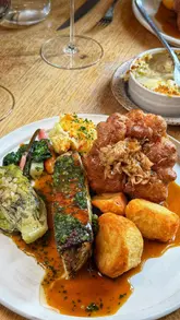 A couple visits Roots York to review their new Summer Sunday Feast menu, showcasing a variety of starters, a main roast course, and dessert.