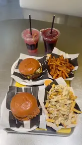 A promotional video for GOAT Burger in Knightsbridge, London, featuring a 'CR7 vs Messi' theme to compare their chicken and wagyu beef burgers. The video showcases various menu items, including burgers, fries, and mocktails, in a bright, modern setting.
