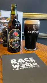 A couple documents their participation in the 'Race Across The World' experience in Edinburgh. The video shows the game materials, the process of navigating the city, and the stops at local bars, highlighting the competitive and fun nature of the activity.