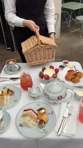 A promotional video for the Ham Yard Hotel featuring their Wimbledon-themed picnic afternoon tea served in a courtyard setting. The video highlights the food presentation and the outdoor atmosphere with tennis screenings in the background.