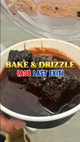 A creator reviews two dessert items, a 'Matilda cake' and mini Dutch pancakes, from a stall called Bake & Drizzle located at the A38 Last Exit food court in Birmingham. The video features the creator trying the food, describing the taste, and providing a rating.