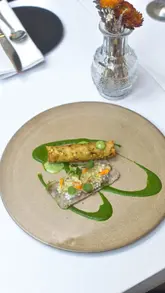 A behind-the-scenes look at chefs at Myrtle Restaurant plating a dish called 'Sultan's Gesture', focusing on the precision and creativity involved in the presentation.