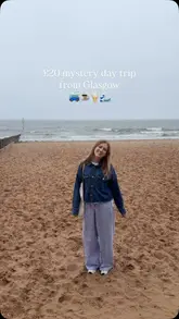 The video documents a mystery day trip from Glasgow, showcasing the bus journey, coastal scenery in Portobello and North Berwick, and stops for coffee, cake, fish and chips, and ice cream.