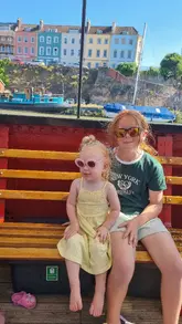 A short video showcasing a boat tour around Bristol's floating harbour, featuring views of the city's colourful buildings and bridges, with children enjoying the ride.