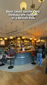 A video review of the Hen & Chickens pub in Birmingham, highlighting its status as a 'secret' Indian restaurant. The creator showcases the interior, the bar, and a variety of Indian dishes including a large grilled platter and curries, emphasizing the quality of the food over trendy aesthetics.
