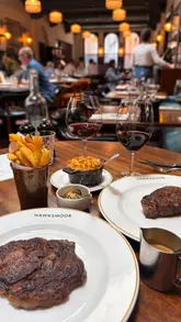 A creator reviews the graduation set menu at Hawksmoor Manchester, showcasing the food, drinks, and the celebratory atmosphere suitable for graduation events.