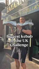 A creator visits Zayaans Indian Bistro in Manchester to attempt a massive kebab food challenge. The video features the creator introducing the challenge, showing the preparation of the large kebab, and sampling the food, including lamb chops.