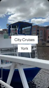 A couple enjoys a fish and chips lunch while on a sightseeing boat cruise along the River Ouse in York. The video captures the experience of eating on the boat, the views of the city from the water, and the relaxed atmosphere of the trip.