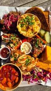 A promotional video for Fat Jack's Shack at Drapers Yard, featuring shots of the venue's exterior, menu, and a detailed look at their BBQ platter.