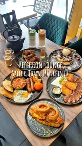 A promotional video for Reflexion Lounge in Salford Quays, Manchester, featuring a variety of brunch dishes including steak, pancakes, waffles, and a croissant burger, alongside shots of the venue's interior and exterior.