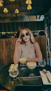 A short video featuring a woman dining at a Japanese-Peruvian restaurant in London, showcasing various sushi dishes and cocktails.