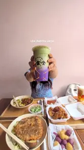 A creator reviews a Taiwanese snack bar, showcasing a variety of bento boxes, bubble teas, and snacks like sweet potato balls and Taiwanese sausage. The video features a mix of close-up food shots and the creator interacting with the items in a casual, friendly setting.