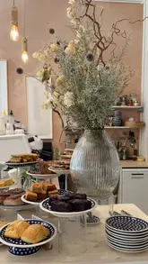 A montage video showcasing the interior, coffee, pastries, and floral arrangements of Stòr Coffee in Edinburgh. The video highlights the dual nature of the venue as both a cafe and a lifestyle/flower shop.