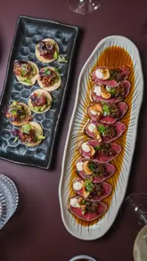 A short, engaging video featuring a visit to Sticks'n'Sushi in London. The creator showcases a variety of dishes including beef tataki, tuna tartare, and a DIY hand roll set, highlighting the interactive and high-quality nature of the food.