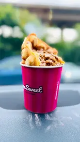 A short video showcasing a visit to a dessert drive-thru, highlighting the ordering process and the various sweet treats purchased, including churros, cookie dough, waffles, and sundaes.