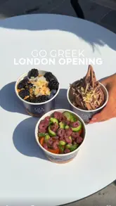 A creator visits the newly opened Go Greek Yogurt in London, showcasing the interior, the self-serve frozen yogurt machines, a variety of toppings, and both sweet and savory yogurt bowl options.