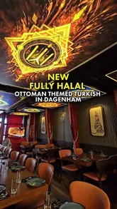 A wide-angle interior shot of a Turkish restaurant in Dagenham, showcasing the Ottoman-themed decor, including ornate ceiling lighting and private dining booths.
