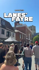 A fast-paced montage capturing the atmosphere of the Norwich Lanes' Fayre, featuring various street food stalls, crowds, and entertainment.
