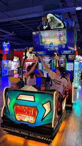 A high-energy, fast-paced video showcasing a visit to Funstation in Leeds, featuring a couple playing various arcade games, VR experiences, and winning prizes.