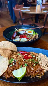A short, vlog-style reel showcasing a lunch deal at Banana Tree. The creator walks into the venue, shows the menu, and highlights the food dishes including prawns, Pad Thai, and Ramen with gyozas.