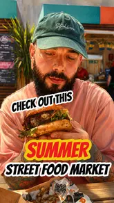 A creator visits the Kerb food market outside the National Theatre on London's Southbank. The video features a review of food from 'The Duck Shed' and 'Barbs', including a duck burger, chicken burger, and fries, while also highlighting the outdoor seating and atmosphere of the market.