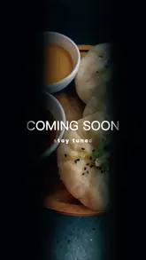 A moody, high-quality teaser video featuring close-up shots of steaming bao buns and dipping sauces, accompanied by 'Coming Soon' text overlays to build anticipation for a new venue opening.