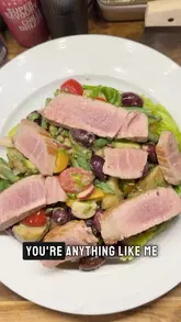 A home cooking tutorial demonstrating how to make a Salade Niçoise, featuring a personal anecdote about a dining experience in Paris.