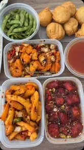 A short, edited video showcasing a Chinese takeaway spread, featuring various dishes like honey chilli chicken, salt and pepper chips, and prawn toast.