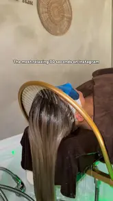 A high-quality, aesthetic promotional video for a head spa, showcasing the relaxing treatment process including washing, scalp massage, and water therapy. The video uses slow, deliberate shots and calming music to convey the luxurious and tranquil nature of the experience.
