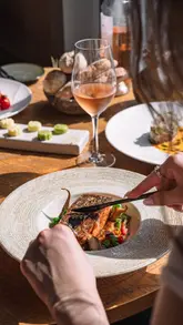 This reel provides a behind-the-scenes look at a professional food photoshoot at Bokan London. It alternates between shots of the photographer setting up the scene and the resulting high-quality images of dishes like steak, salmon, and a cheese board, all set against a backdrop of the London skyline.