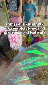 A montage of clips showing a family at a festival, specifically focusing on a child meeting a 'Wish Fairy' and making a wish on a giant dandelion.