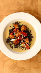 A high-quality recipe tutorial video demonstrating how to make a coconut, lemongrass, and tofu curry. The video features the creator introducing the dish, followed by clear, step-by-step cooking shots, and concludes with the final plated result.