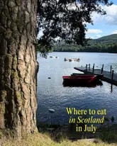 A high-quality, scenic landscape photograph of a Scottish loch featuring a jetty and small boats, used as a cover image for a listicle recommending various hospitality venues in Scotland.