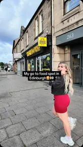 A creator visits Shakedown in Edinburgh, showcasing the menu, interior, and various food items including burgers, loaded fries, chicken strips, milkshakes, and cookie dough. The video features the creator trying the food and providing a positive review.