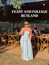 A lifestyle-focused shot featuring a woman holding a drink in a beautifully set-up walled garden, promoting a supper club event.