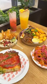 A short montage showcasing various food and drink items from different traders at Saint Paul's Market in Birmingham, including pizza, kebabs, and cocktails.