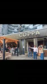 A montage of clips from a terrace launch party at Coppa Club, featuring views of the London skyline, cocktail preparation, and canapés.