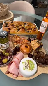 A first-person tour of Blacker Hall Farm Shop, highlighting the butchery, fresh produce, bakery, and deli counters, culminating in a selection of items for a charcuterie board.