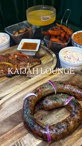 A review of Kaijah Lounge in Manchester, showcasing their Zimbabwean menu, including grilled fish, boerewors, and cocktails, alongside the restaurant's interior.