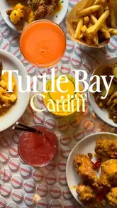 A promotional reel featuring two friends visiting Turtle Bay, showcasing the menu, cocktails, and food offerings, while highlighting the evening atmosphere and drink deals.