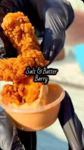 A creator reviews a takeaway venue called Salt & Batter in Barry, showcasing various menu items including Nashville hot tenders, masala fish, a smash burger, and a munch box. The video features the creator tasting the food, showing the packaging, and providing a brief tour of the shop front.