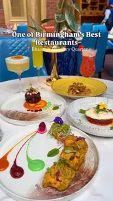 A high-quality, overhead flat-lay shot showcasing a diverse spread of Nepalese dishes and cocktails at a restaurant. The image highlights vibrant plating, varied textures, and a clean, well-organized table setting that effectively communicates the variety and quality of the menu.