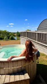 A montage showcasing a stay at Foxholes Farm, highlighting the glamping pods, private hot tub, farm animals, and family-friendly activities like the play area and sandpit.