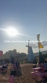 A montage of a visit to a sunflower farm and cider festival, featuring shots of the fields, cider, and street food.