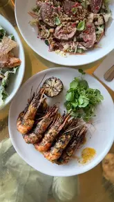 A group of friends visits The Lighterman in King's Cross, showcasing the waterfront location, cocktails, and a variety of dishes including pizza, salad, prawns, and dessert.