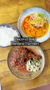 A review of a meal at Lahpet, featuring a variety of Burmese dishes including corn fritters, prawn salad, hake masala, duck curry, and a pandan coconut crème brûlée, alongside cocktails.