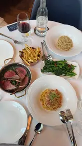 A visually appealing montage showcasing a variety of dishes and the elegant interior of Sale e Pepe Mare, a Riviera-inspired Italian restaurant in London.