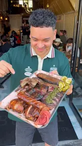 A high-energy, engaging review of a Texas-style BBQ smokehouse in London, showcasing the cooking process, various meat dishes, and the restaurant's atmosphere.
